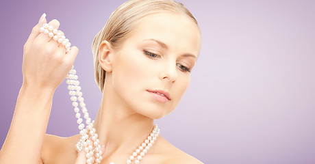 Image showing beautiful woman with pearl necklace over violet