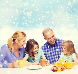 Image showing happy family with two kids having breakfast