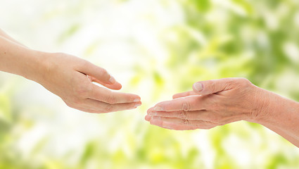 Image showing close up of senior and young woman hands