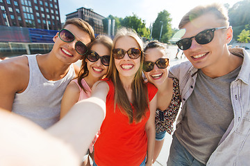 Image showing smiling friends taking selfie