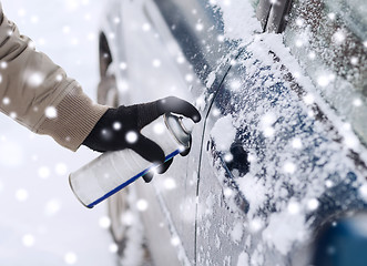 Image showing closeup of man hand with lock door de-icer