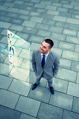 Image showing young smiling businessman outdoors from top