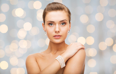 Image showing beautiful woman with pearl earrings and bracelet