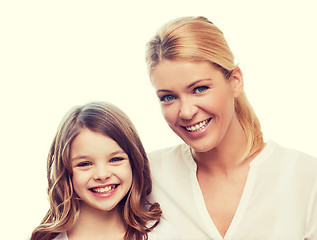 Image showing smiling mother and little girl at home