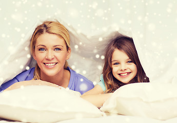 Image showing happy mother and girl under blanket at home