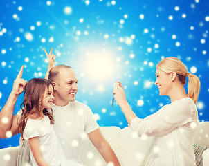 Image showing happy family with camera at home