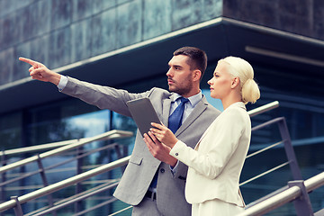 Image showing serious businessmen with tablet pc outdoors