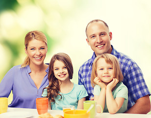 Image showing happy family with two kids with having breakfast