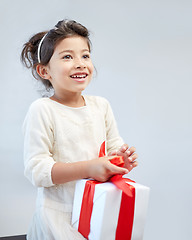 Image showing happy little girl with gift box at home