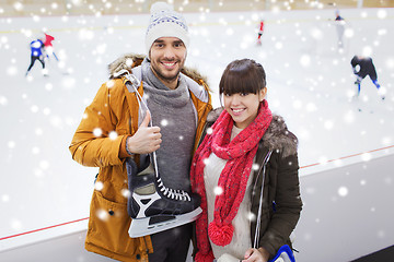 Image showing happy couple with ice-skates on skating rink