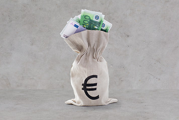 Image showing close up of euro paper money in bag over concrete