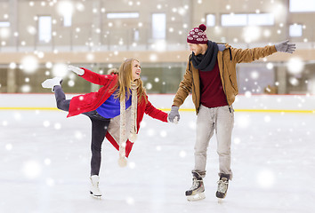 Image showing happy couple holding hands on skating rink