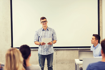 Image showing group of smiling students and teacher in classroom