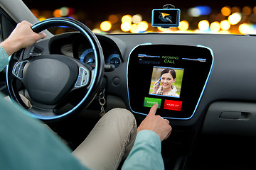 Image showing close up of man driving car and receiving call