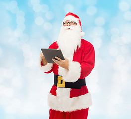 Image showing man in costume of santa claus with tablet pc