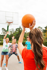 Image showing group of happy teenagers playing basketball