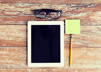 Image showing close up of tablet pc, eyeglasses and pencil