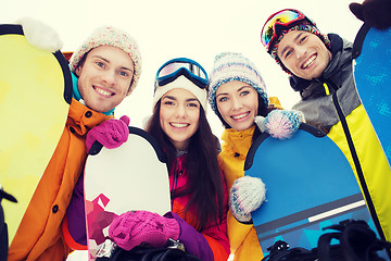 Image showing happy friends with snowboards