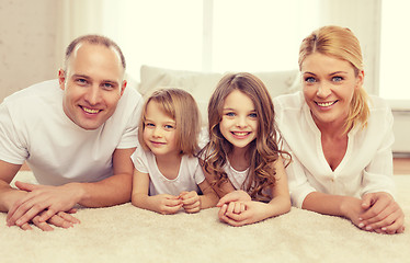 Image showing parents and two girls lying on floor at home