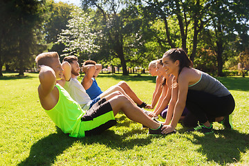 Image showing group of friends or sportsmen exercising outdoors