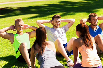 Image showing group of friends or sportsmen exercising outdoors