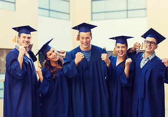 Image showing group of smiling students in mortarboards