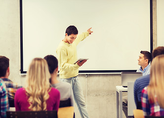 Image showing group of smiling students and teacher in classroom