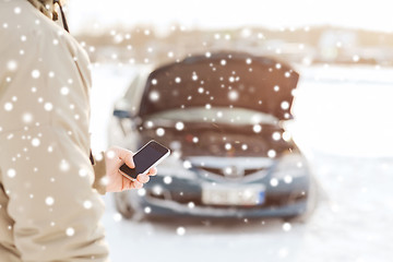 Image showing closeup of man with broken car and smartphone