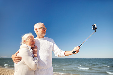 Image showing seniors with smartphone taking selfie on beach