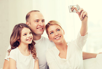Image showing happy family with little girl making self portrait