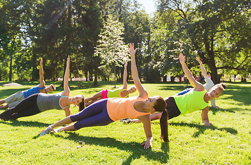 Image showing group of happy friends exercising outdoors