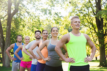 Image showing group of happy friends or sportsmen outdoors