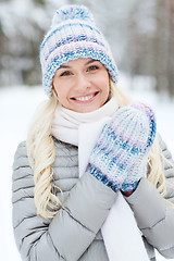 Image showing smiling young woman in winter forest