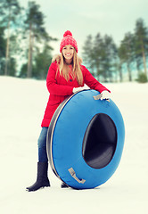 Image showing happy teenage girl or woman with snow tube