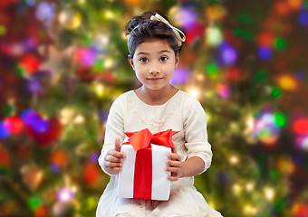 Image showing happy little girl with present over lights