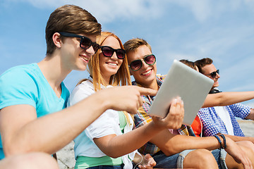 Image showing group of smiling friends with tablet pc outdoors