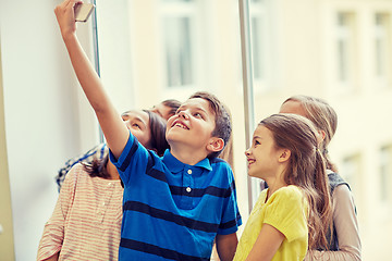 Image showing group of school kids taking selfie with smartphone