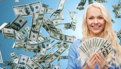 Image showing smiling businesswoman with dollar cash money