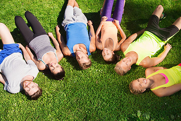 Image showing group of happy sporty friends in circle outdoors