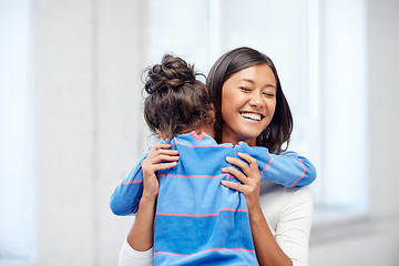 Image showing happy mother and daughter hugging at home