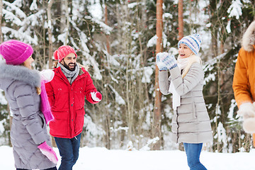 Image showing happy friends playing snowball in winter forest