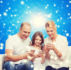 Image showing happy family with smartphones