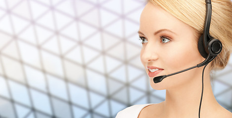 Image showing helpline operator in headset over grid background