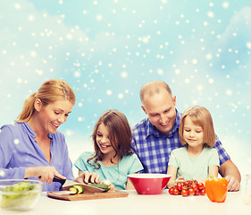 Image showing happy family with two kids making dinner at home