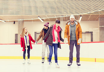 Image showing happy friends on skating rink