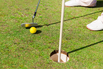 Image showing close up of man with club and ball playing golf