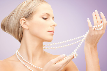 Image showing beautiful woman with pearl necklace over violet
