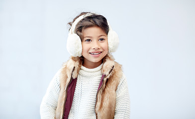 Image showing happy little girl wearing earmuffs