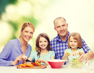 Image showing happy family with two kids making dinner at home