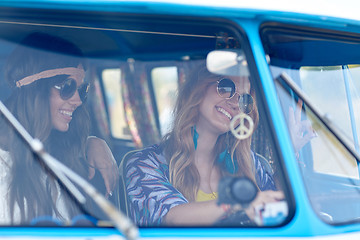 Image showing smiling young hippie women driving minivan car